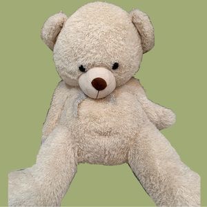 giant tan coloured stuffed bear with silver highlights